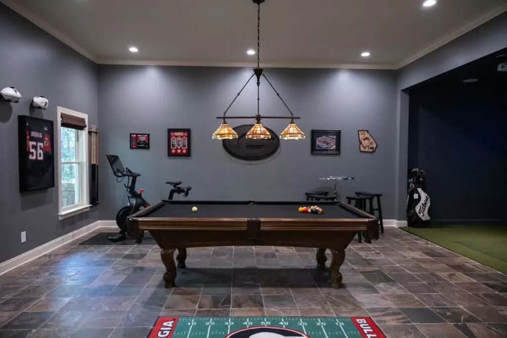 There is a pool table in the middle of the room.