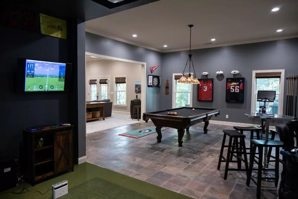 There is a pool table in the middle of the room.