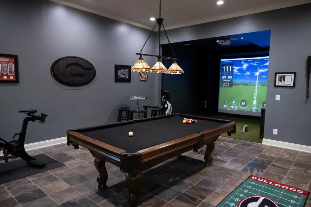 There is a pool table in the middle of the room.
