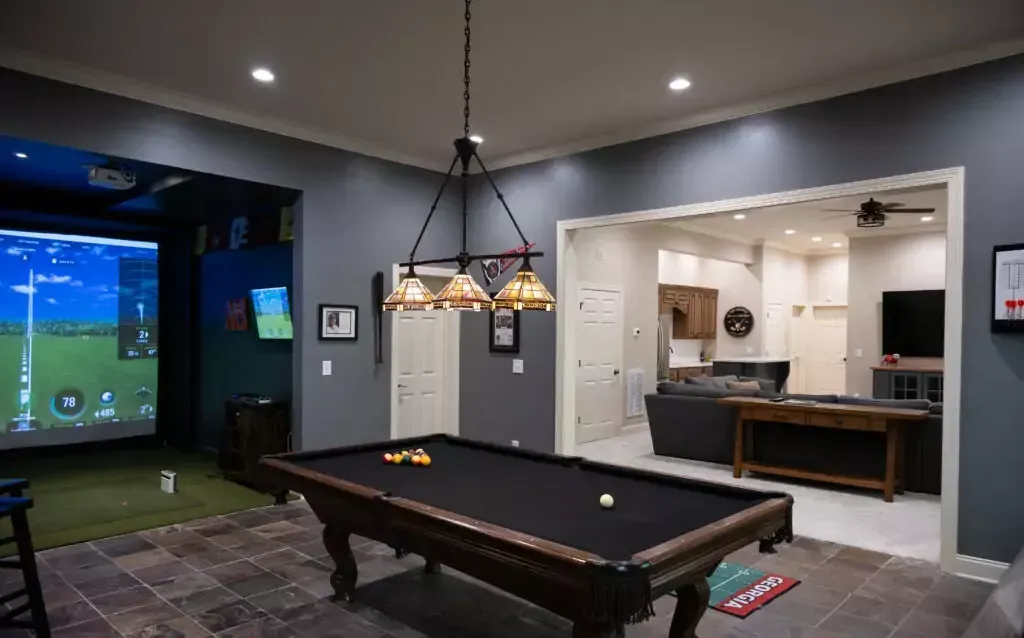 There is a pool table in the middle of the room.