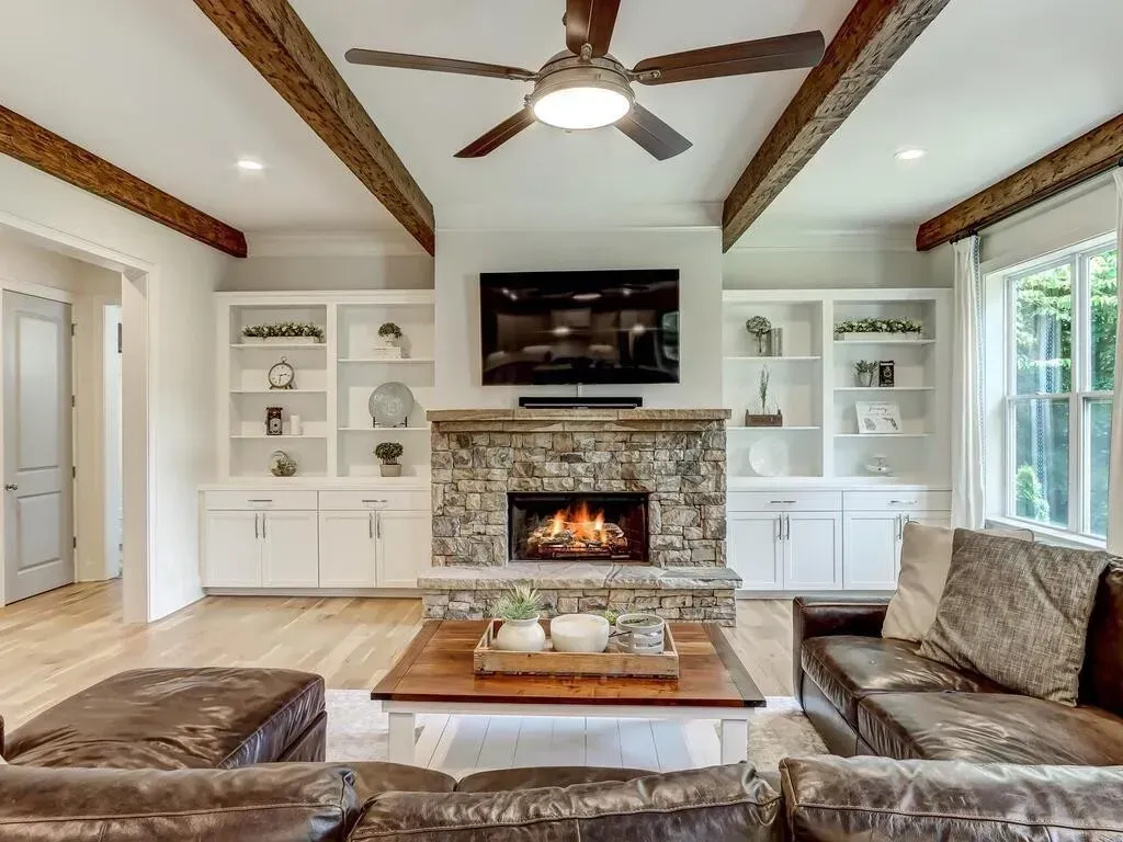 There is a fireplace in the middle of the living room.
