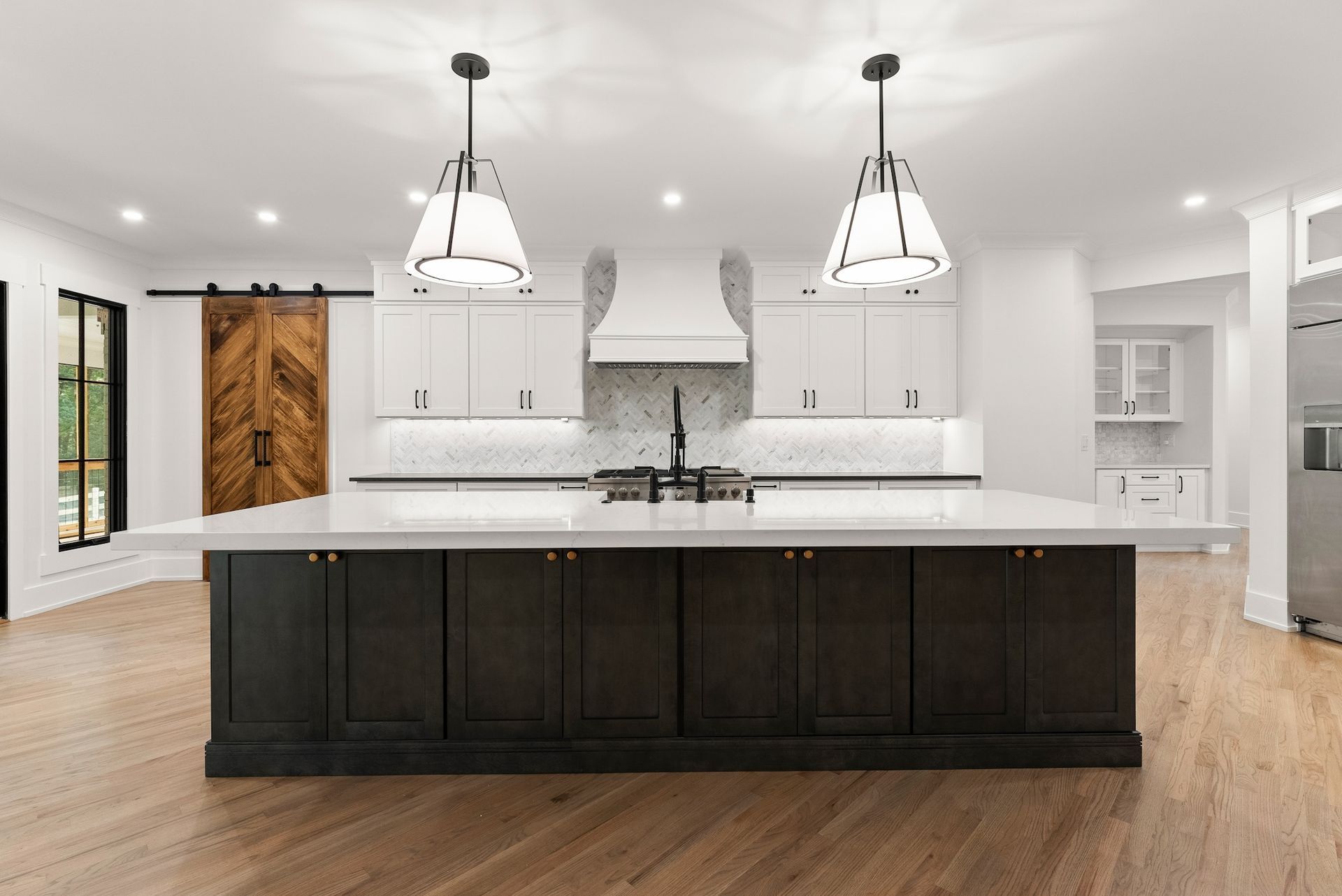 There is a large island in the middle of the kitchen.