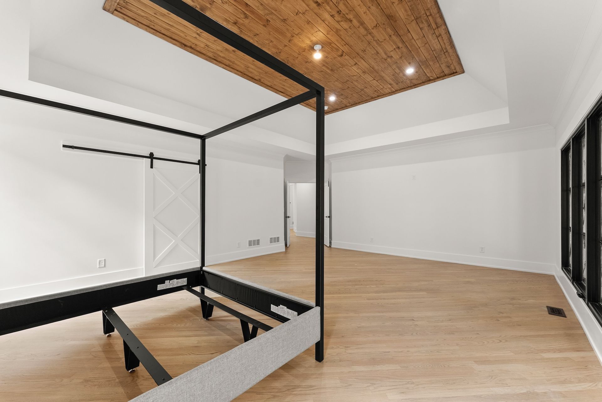 There is a canopy bed in the middle of the room.