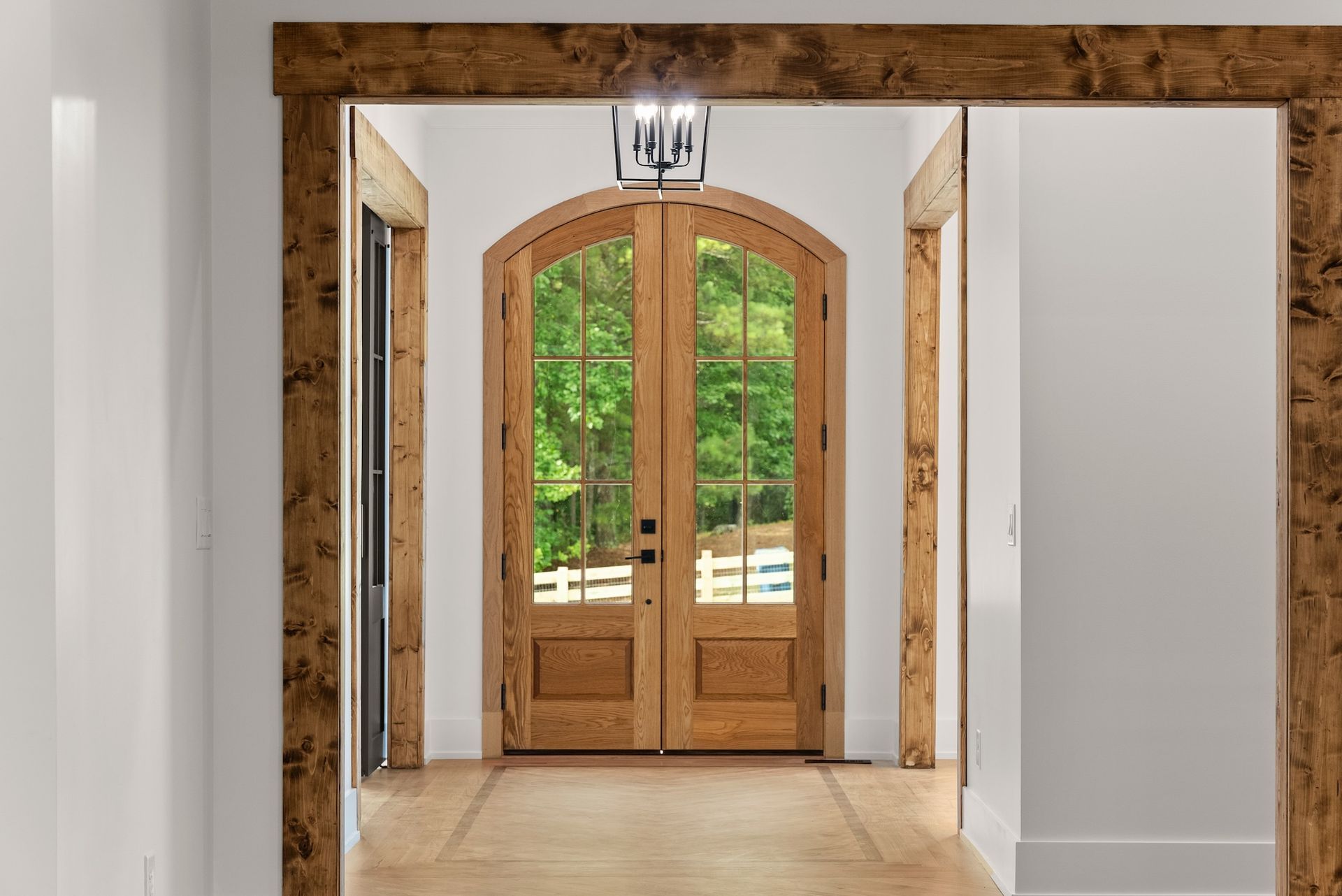 A hallway with a wooden door and a wooden frame.