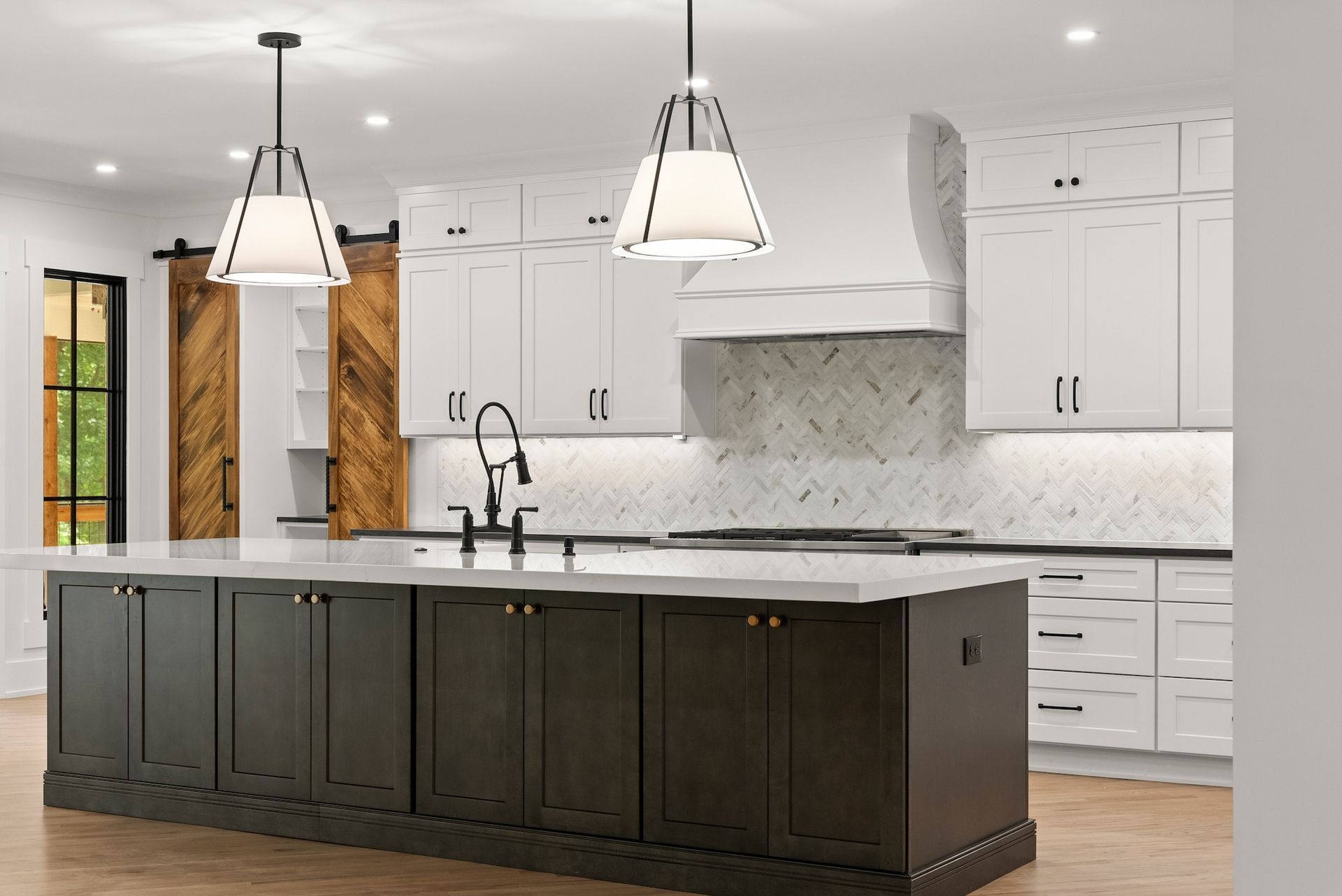 A kitchen with a large island and stainless steel appliances.