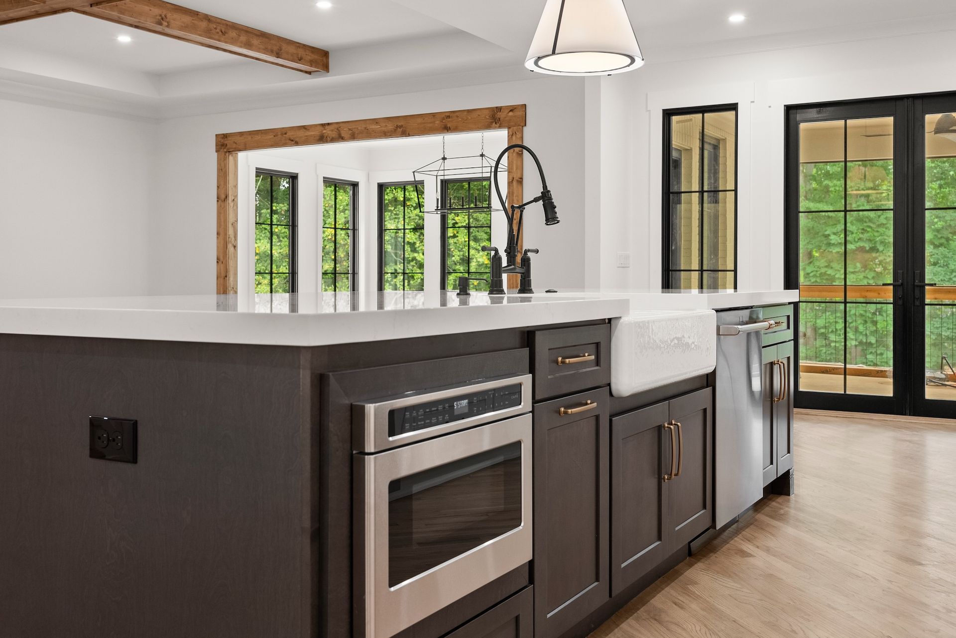 A kitchen with a large island and stainless steel appliances.