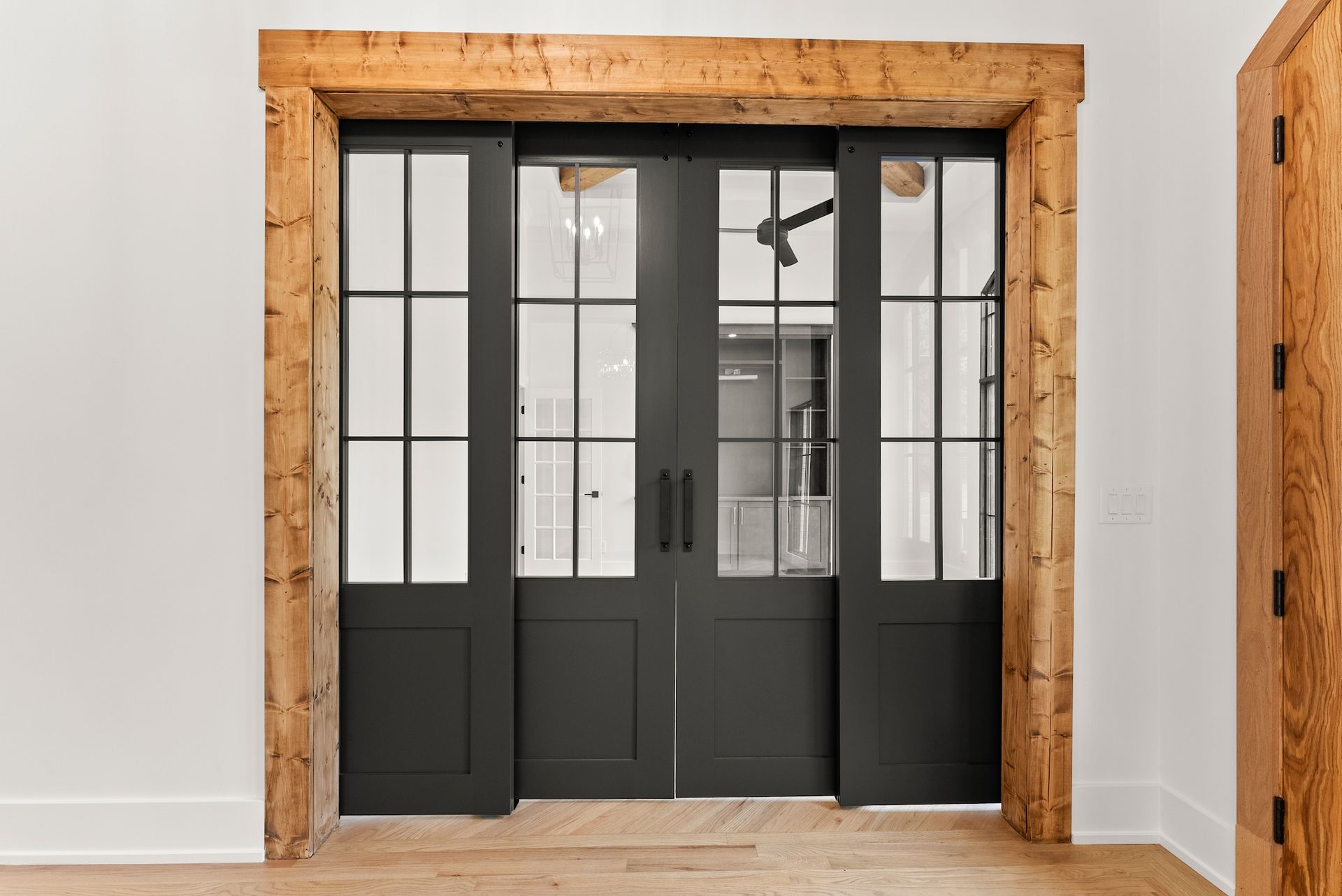 A room with sliding glass doors and a wooden frame.