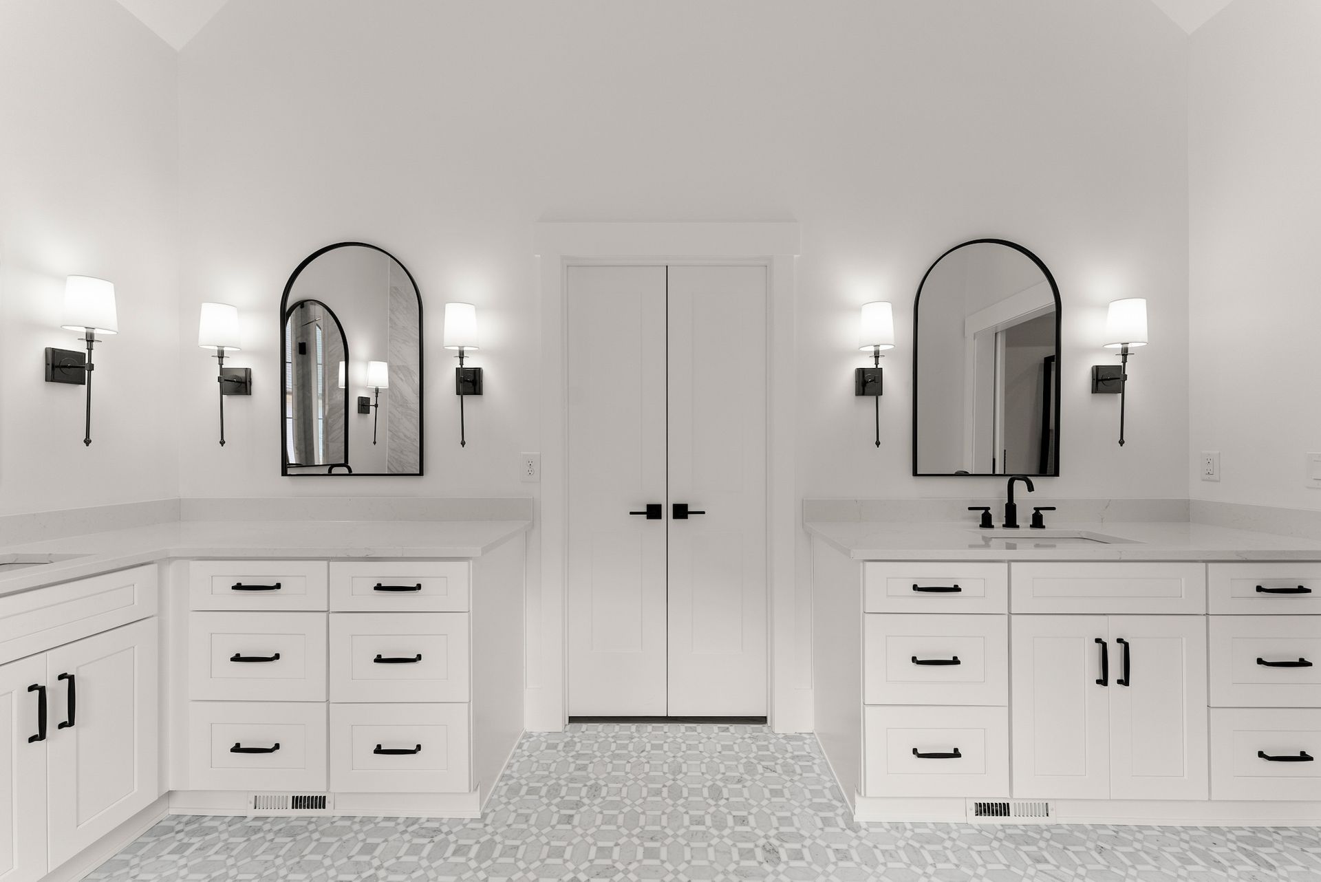 A bathroom with two sinks and two mirrors.