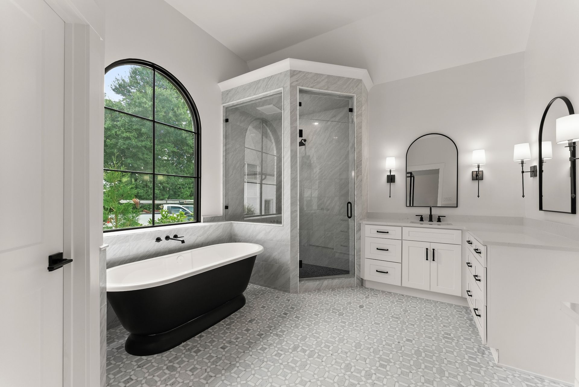 A bathroom with a bathtub , sink , and shower.