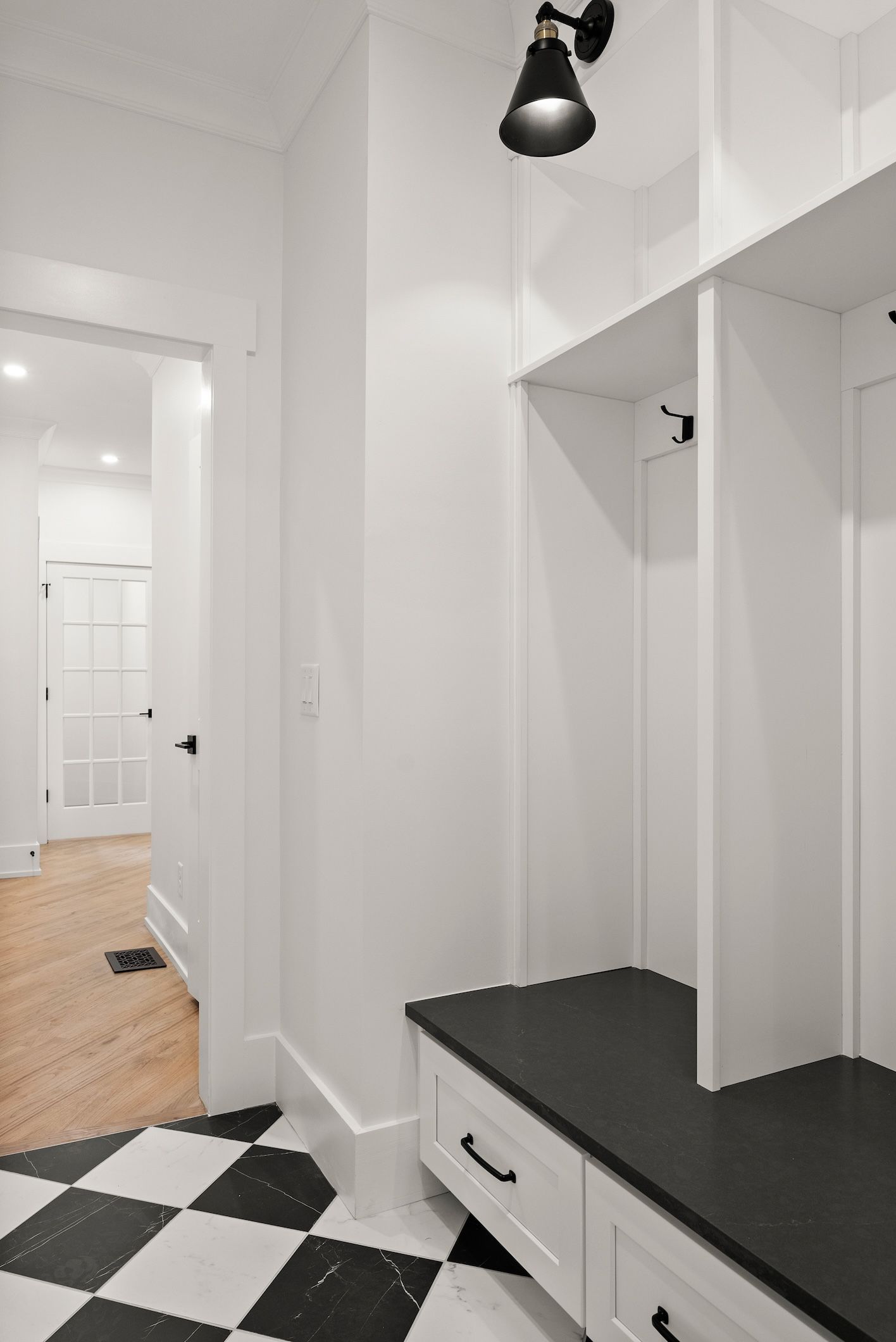 There is a black and white checkered floor in the hallway.