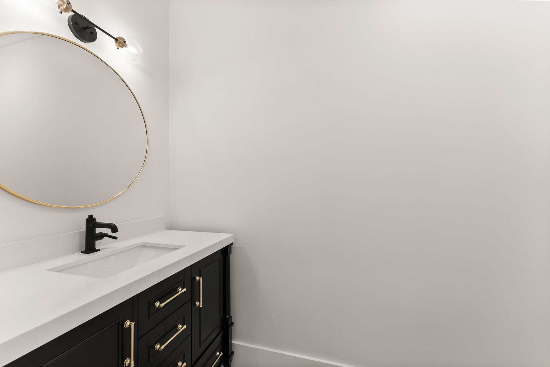 A bathroom with a sink , mirror and dresser.