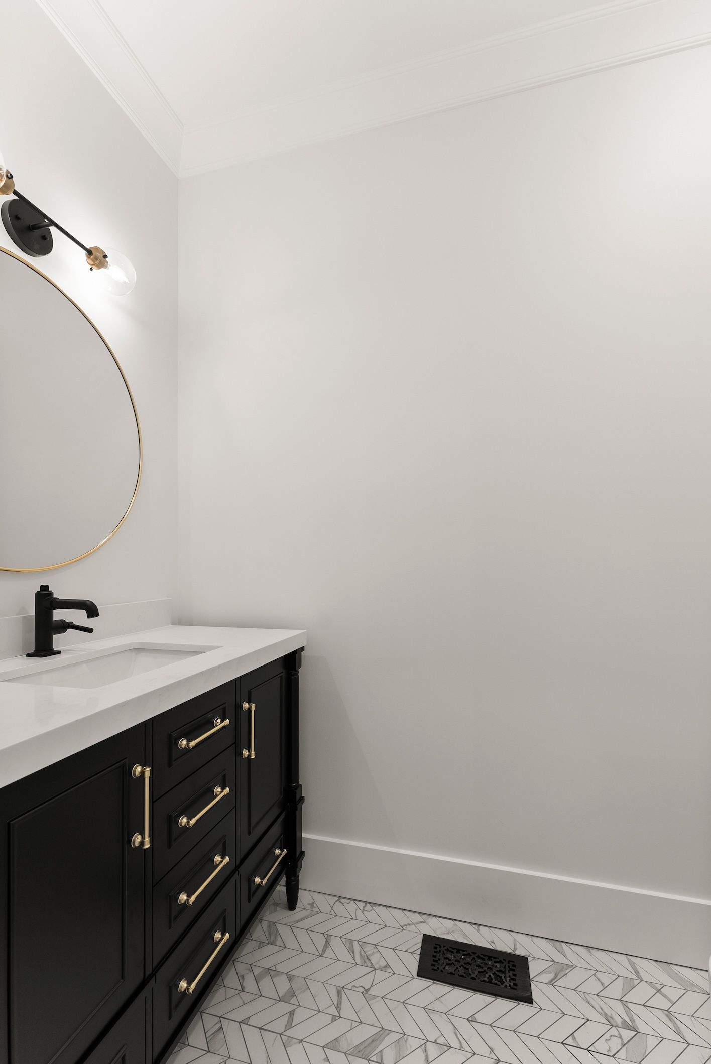 A bathroom with a sink , mirror , and drawers.