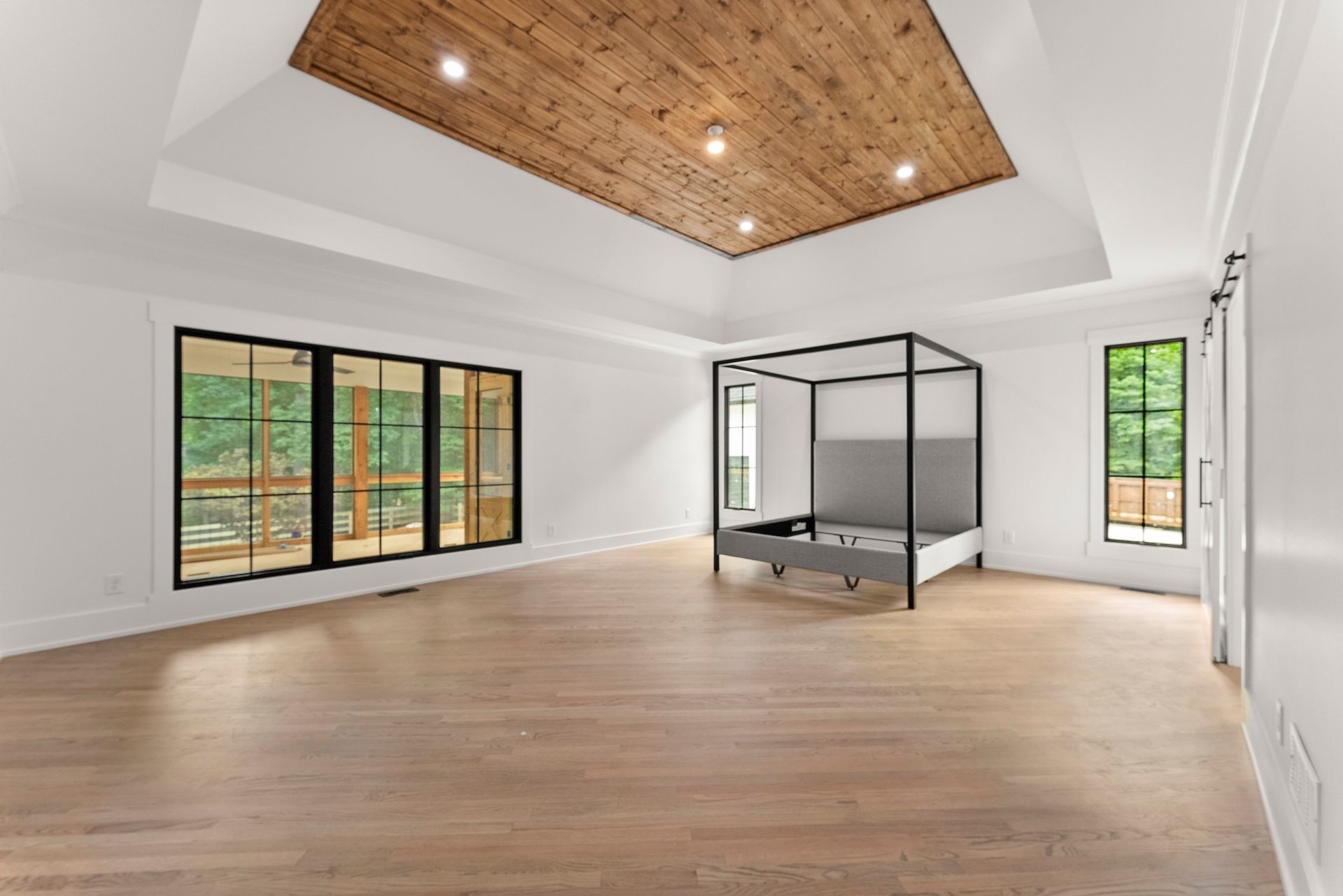 There is a canopy bed in the middle of the room.