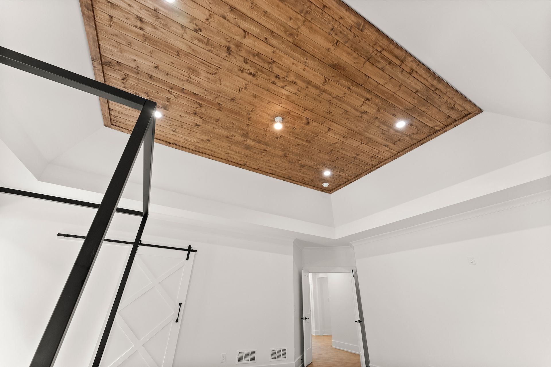 A room with a wooden ceiling and white walls.