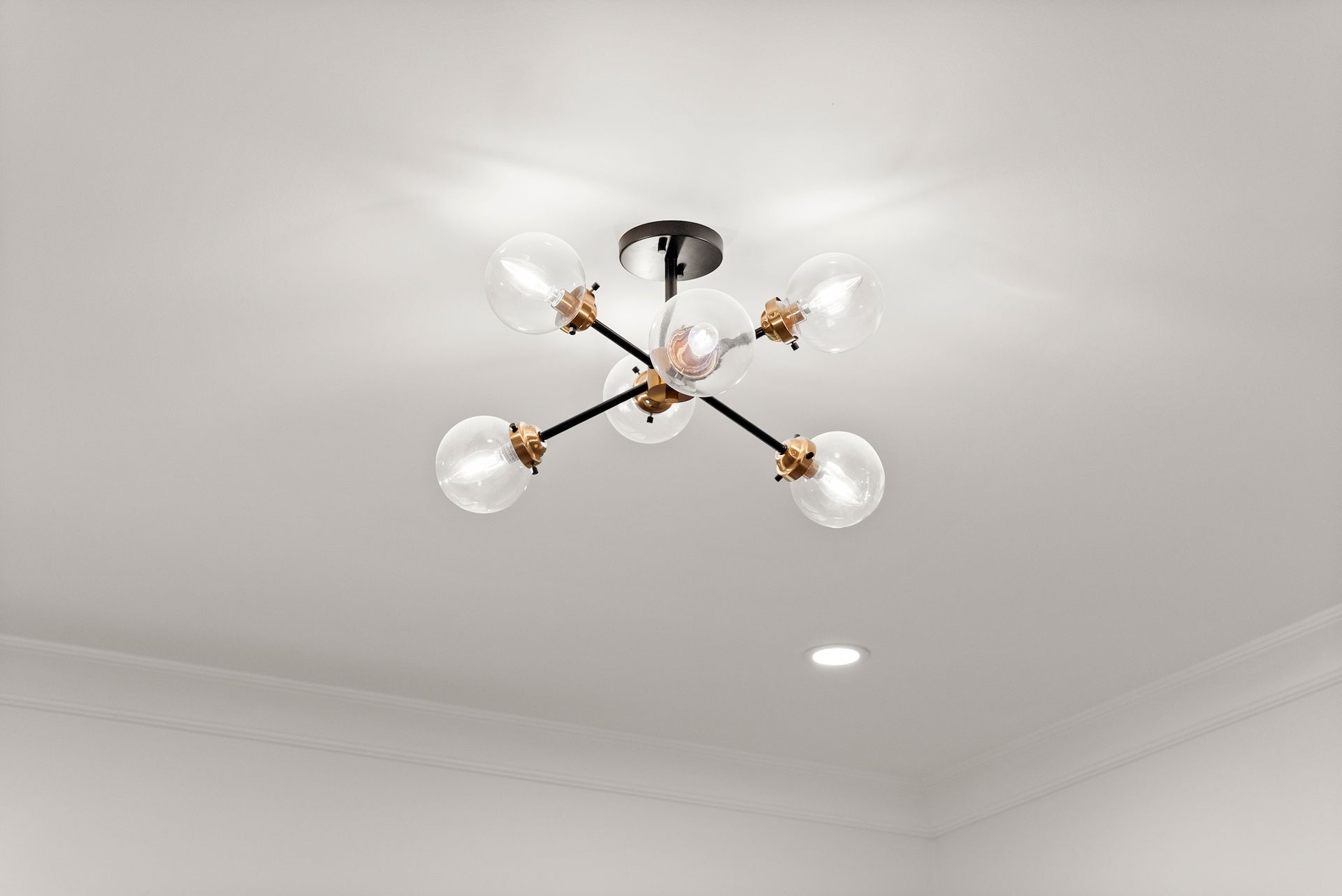 A chandelier is hanging from the ceiling in a room.
