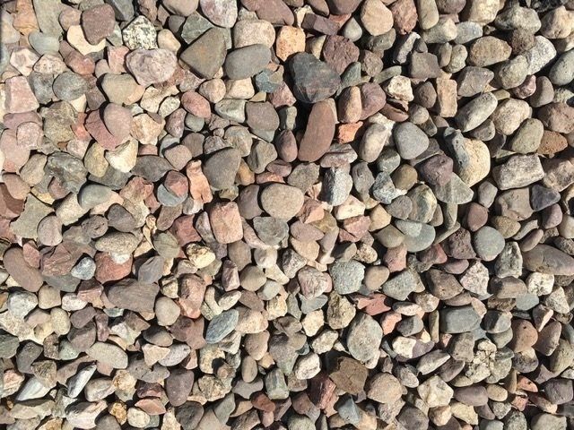 Close-up of a pile of rounded, mixed-color gravel rocks.