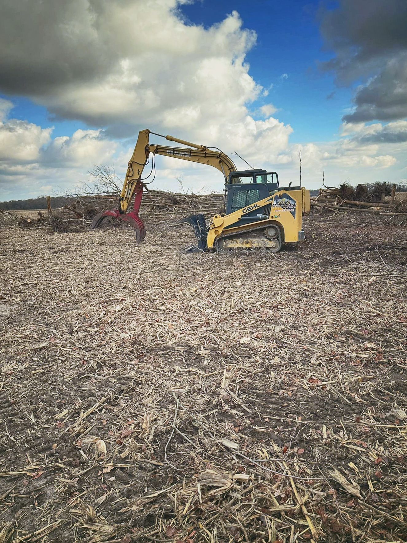 A bulldozer is sitting in the middle of a field.