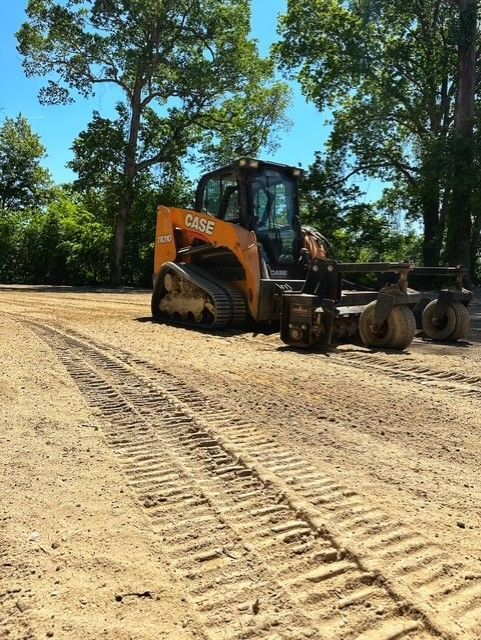 A case bulldozer is parked on a dirt road