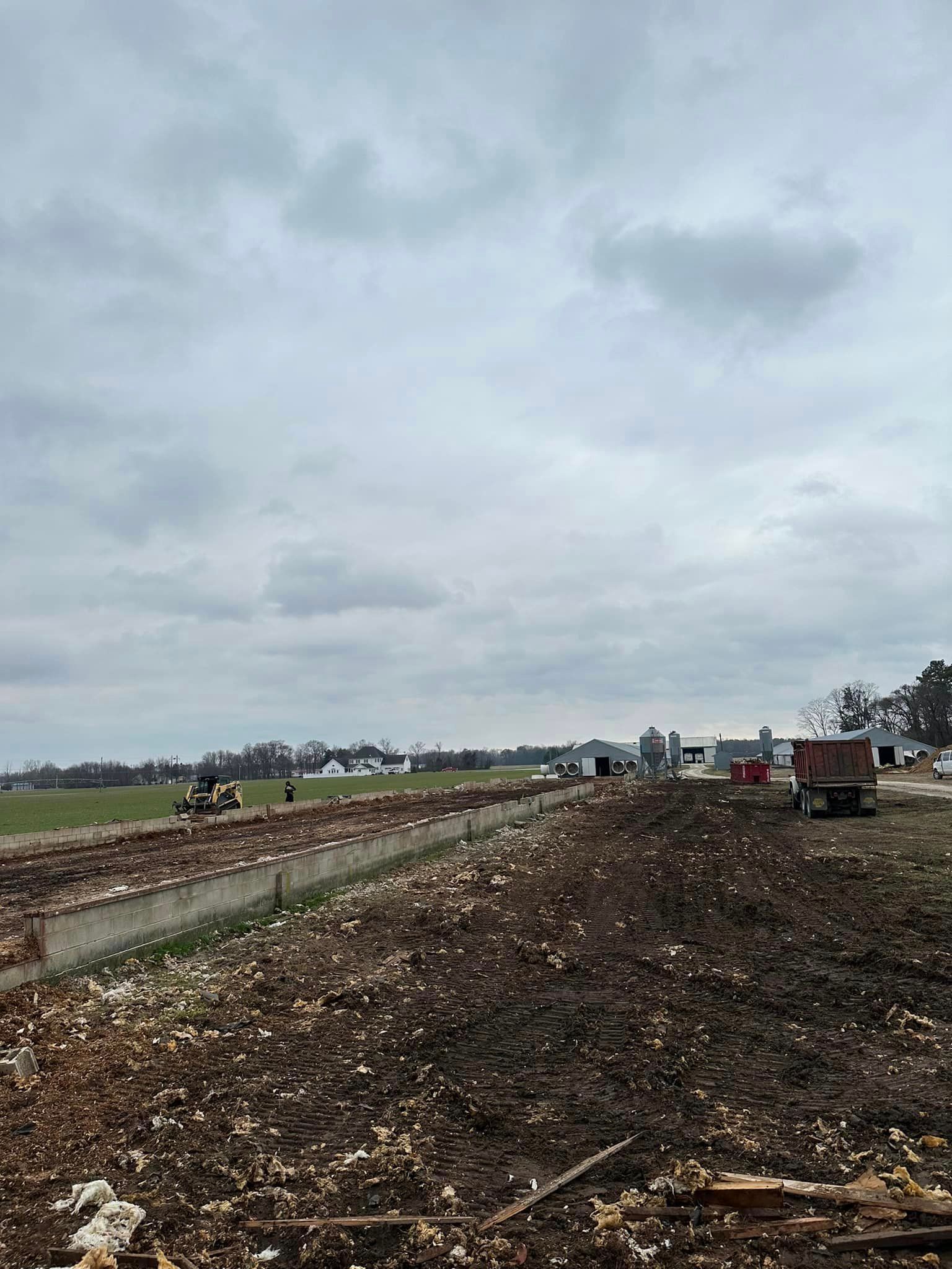 A large pile of dirt is sitting in the middle of a field.