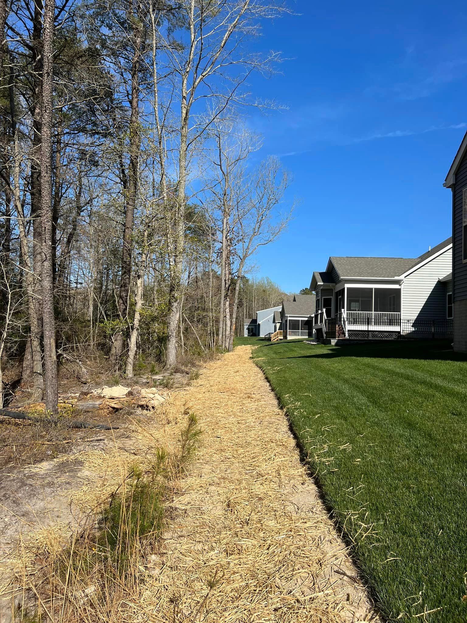 A house with a screened in porch and a path leading to it.