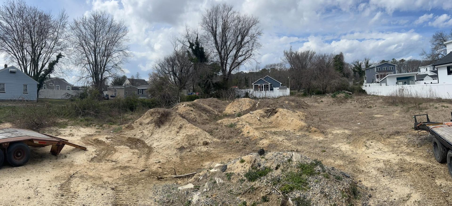 A large pile of dirt is sitting in the middle of a dirt field.