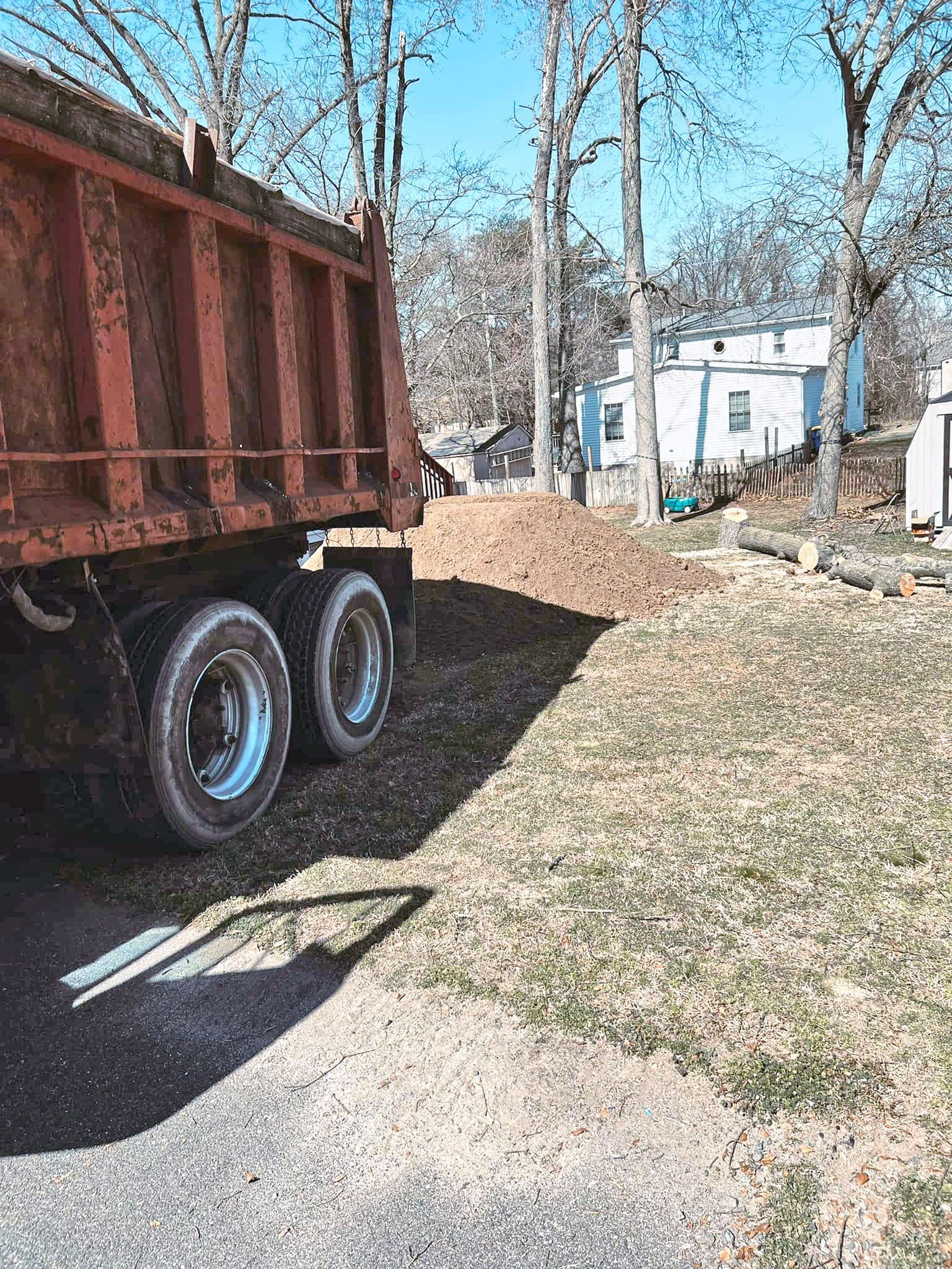 A dump truck is parked on the side of the road.