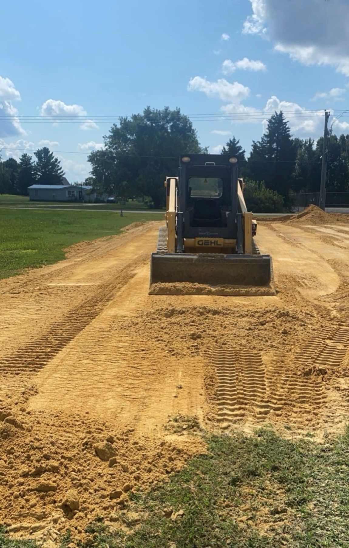 A bulldozer is moving dirt on a dirt road