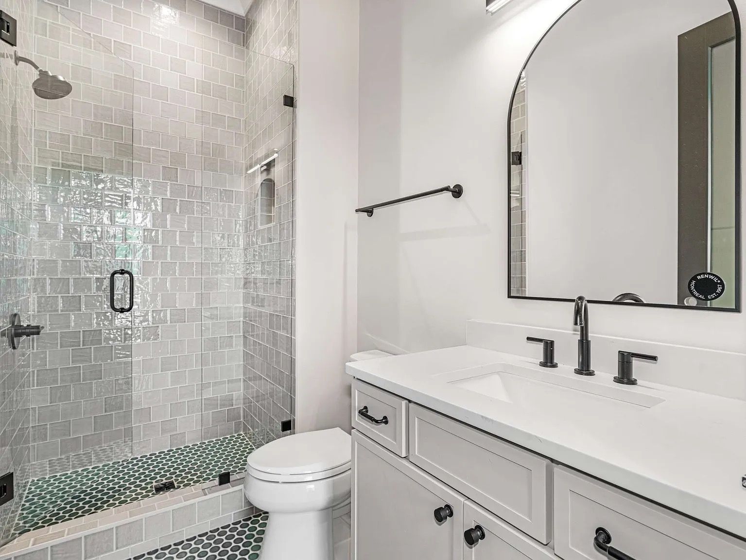 Luxury kitchen backsplash with mosaic tile behind a stainless steel stove and decorative hood