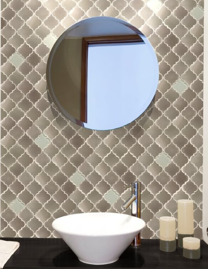 Modern bathroom vanity with round mirror, white bowl sink, and beige patterned tile wall.