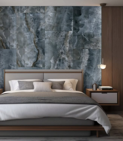 Modern bedroom with a large bed, gray stone accent wall, and warm wood paneling.