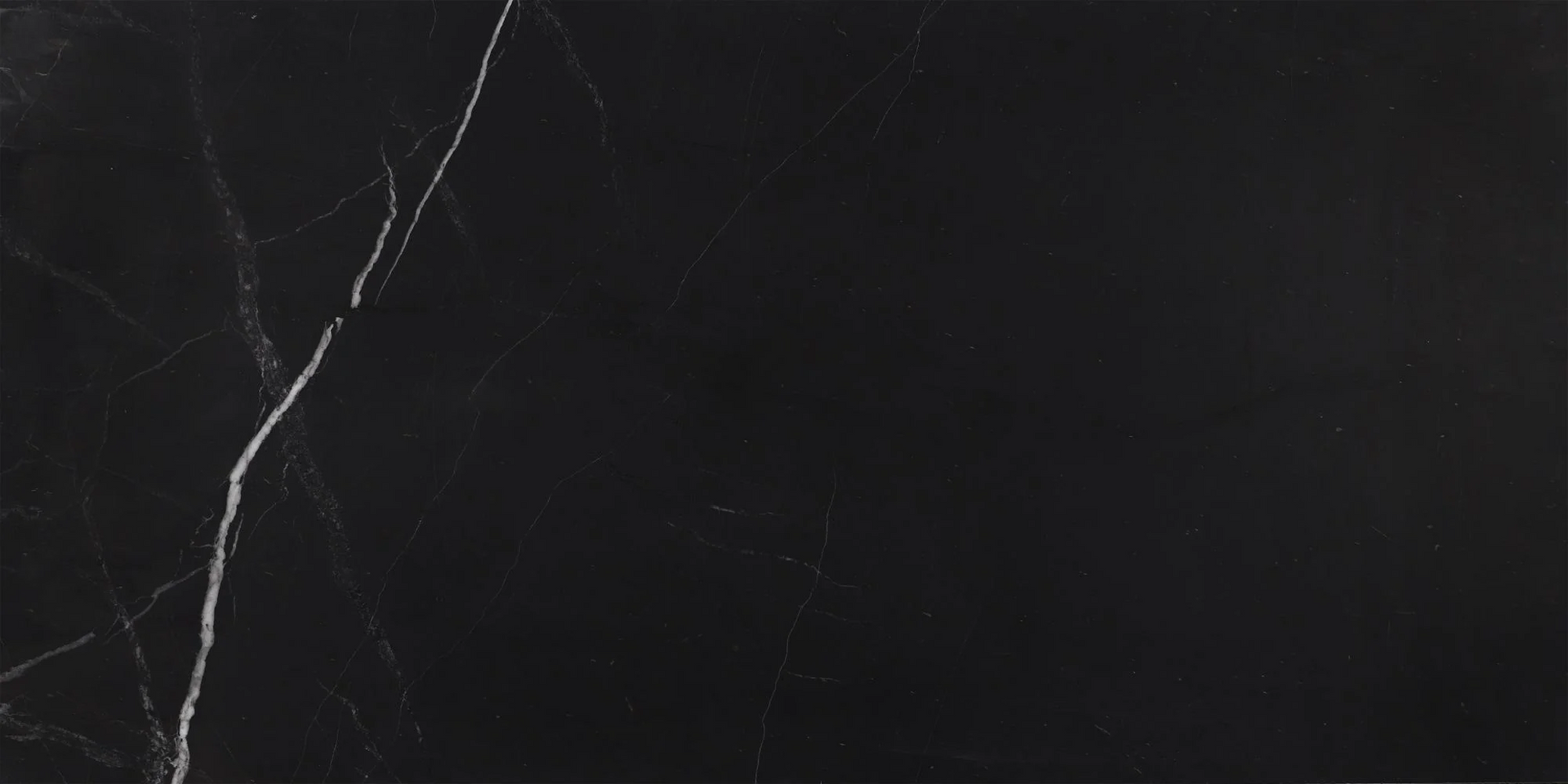 Dark gray marble surface with thin white veining diagonally across the left side