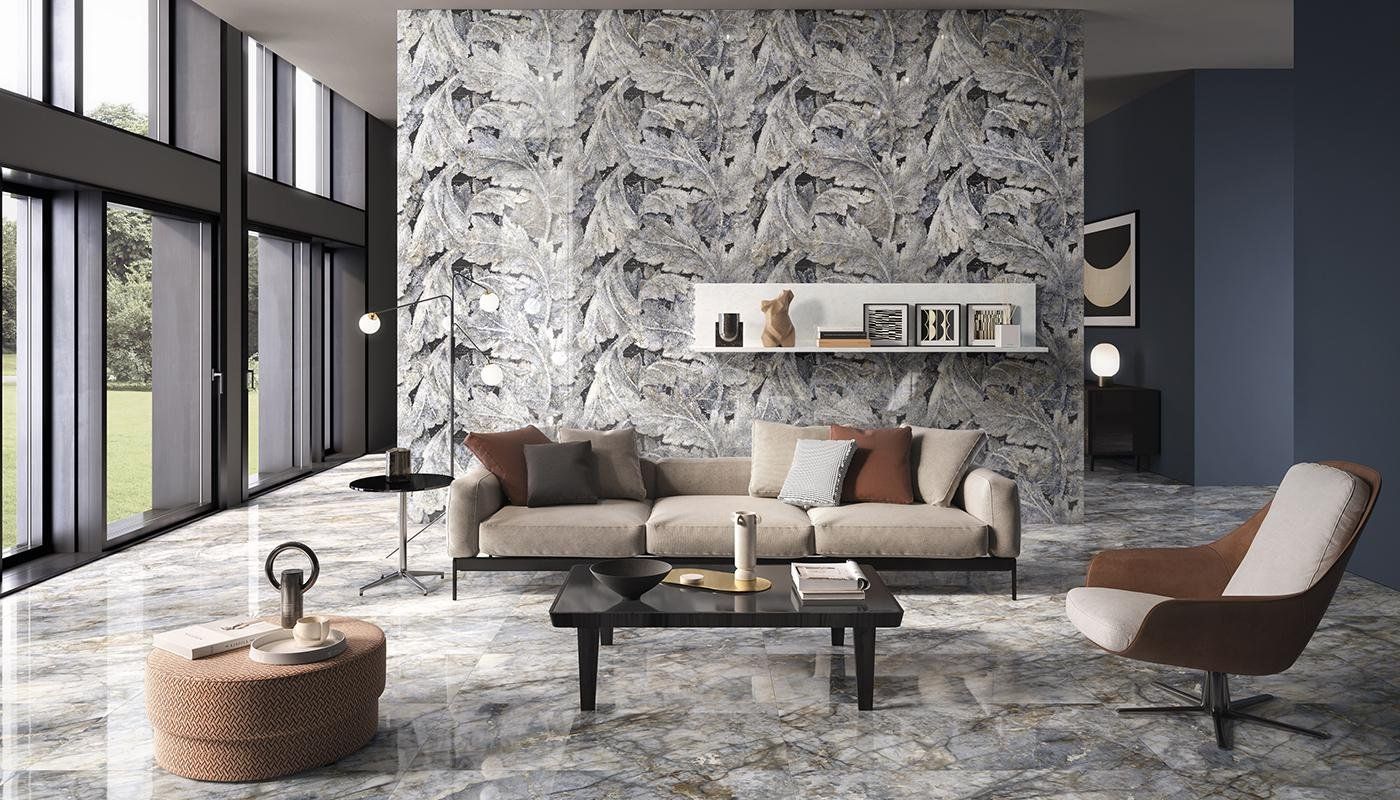 Modern living room with a gray sofa, textured stone wall, brown chair, and large windows.