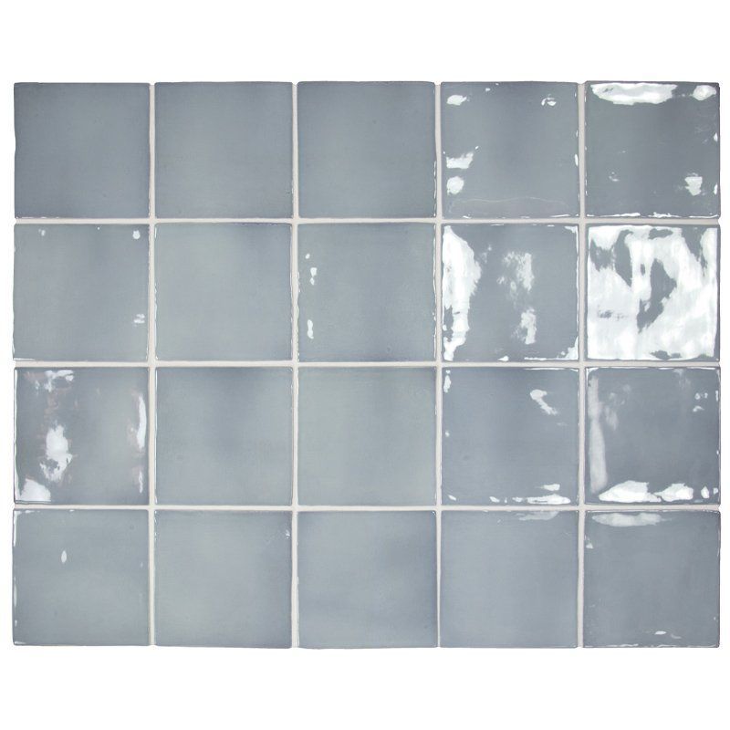 Grid of light gray ceramic tiles with uneven white chipped patches on the right side