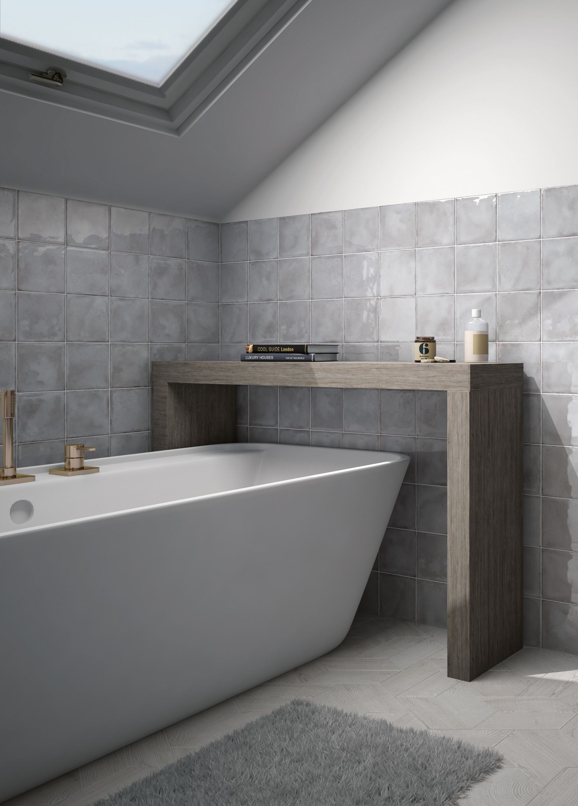 Modern bathroom with a freestanding tub, gray tile walls, and a skylight.