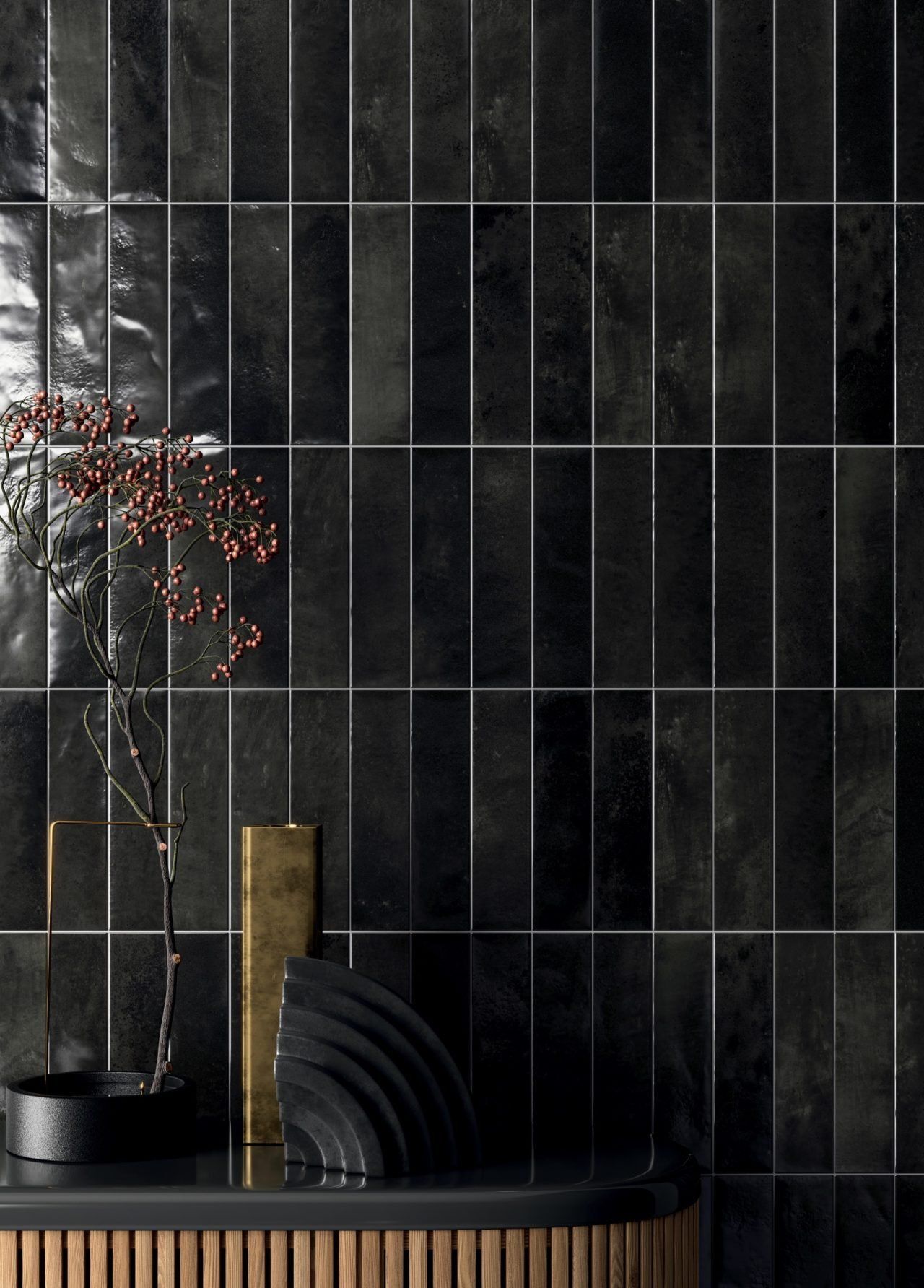Minimalist interior with dark tiled wall, black shelf, and a vase with branches and gold decor