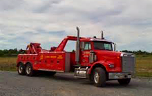 Red wrecker towing a vehicle