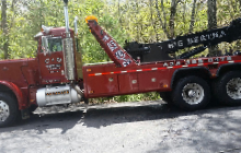 Red wrecker towing a vehicle