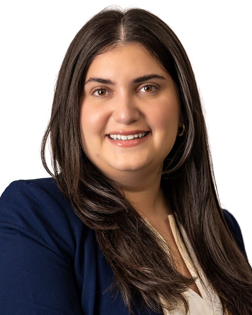 Woman with long dark hair smiles, wearing a navy blazer over a white blouse, against a white background.