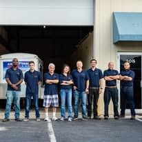 A group of people are standing in front of a building.