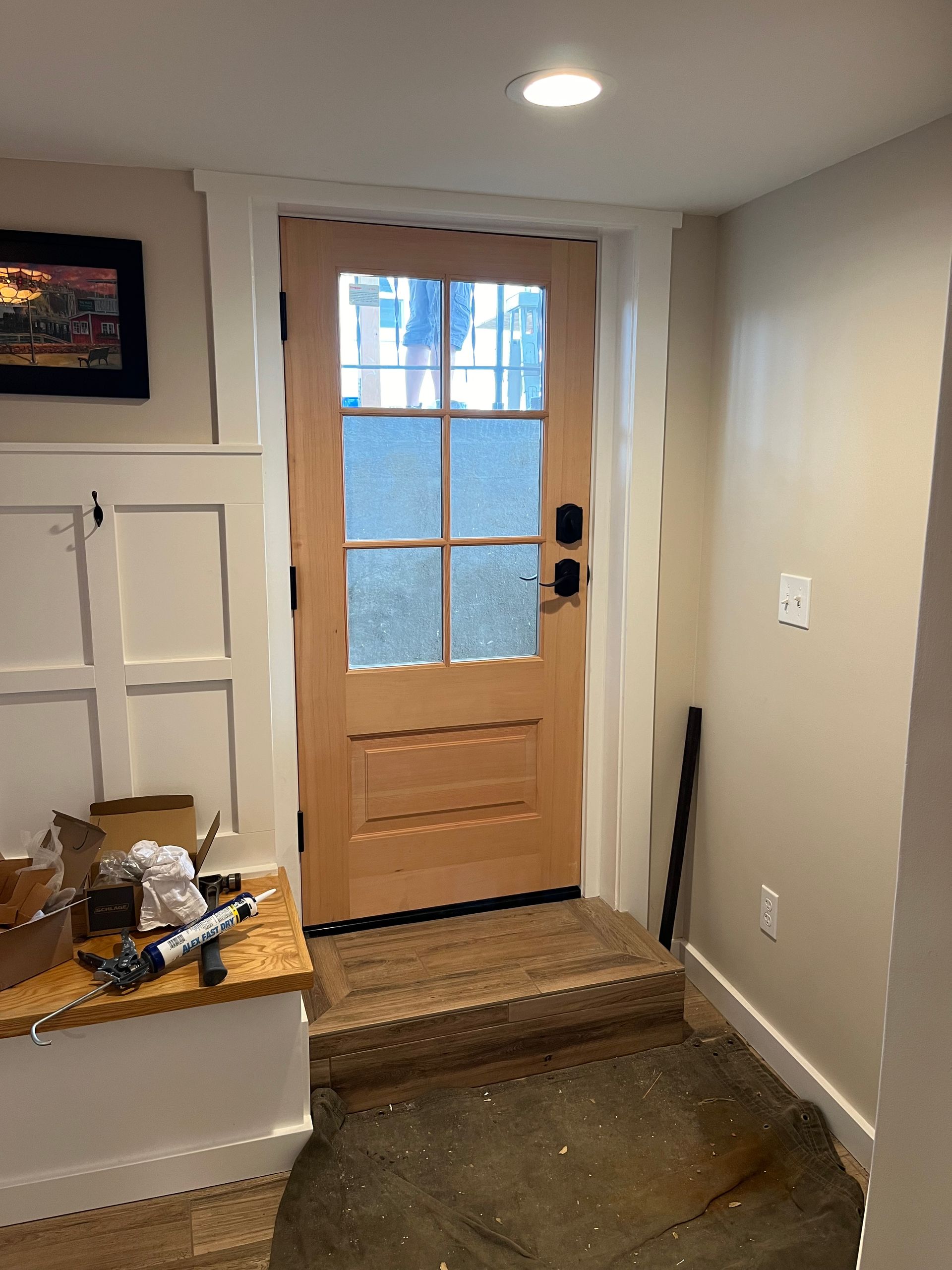 A wooden door with a glass window in a hallway