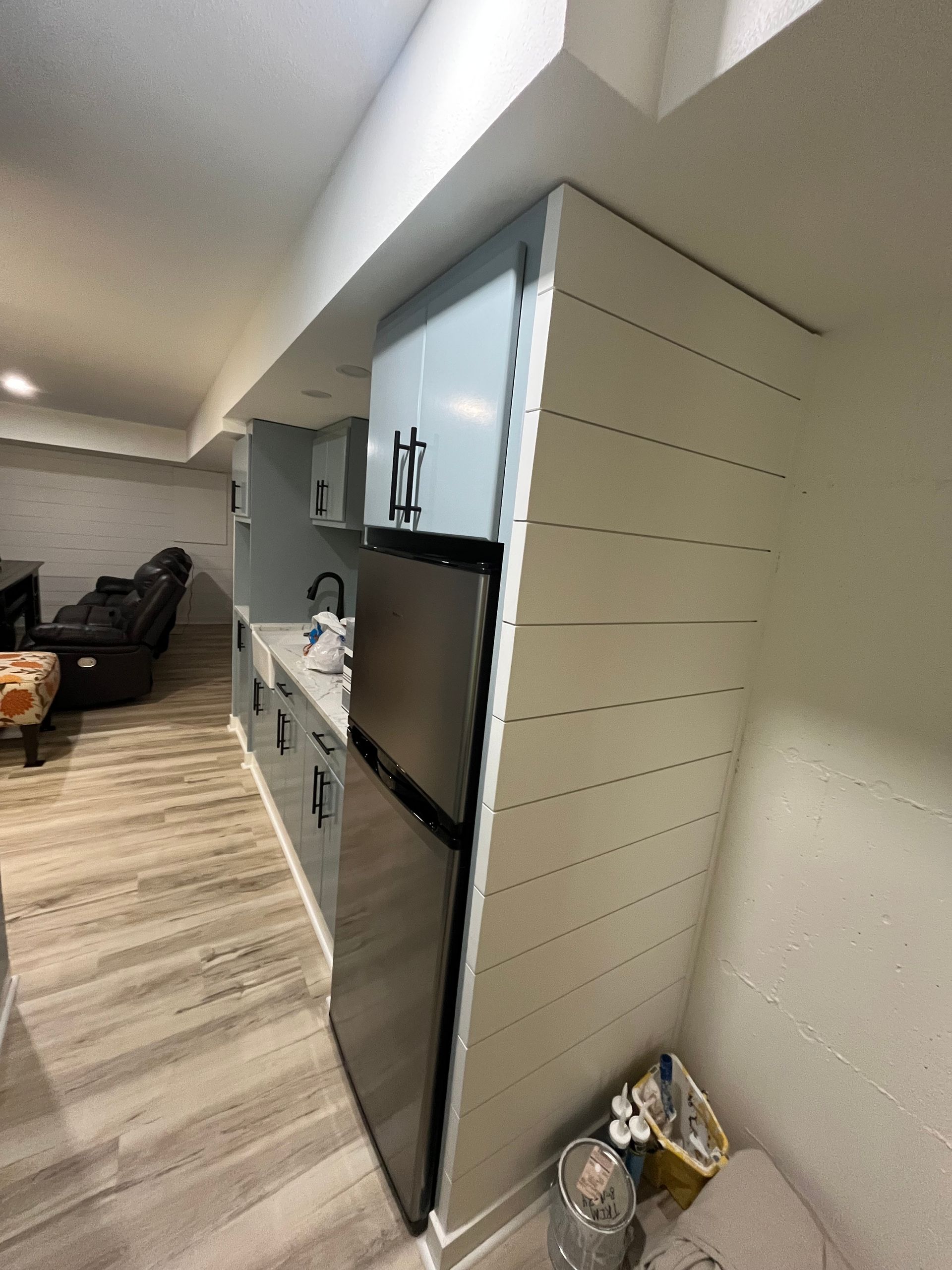 A kitchen with stainless steel appliances and white cabinets