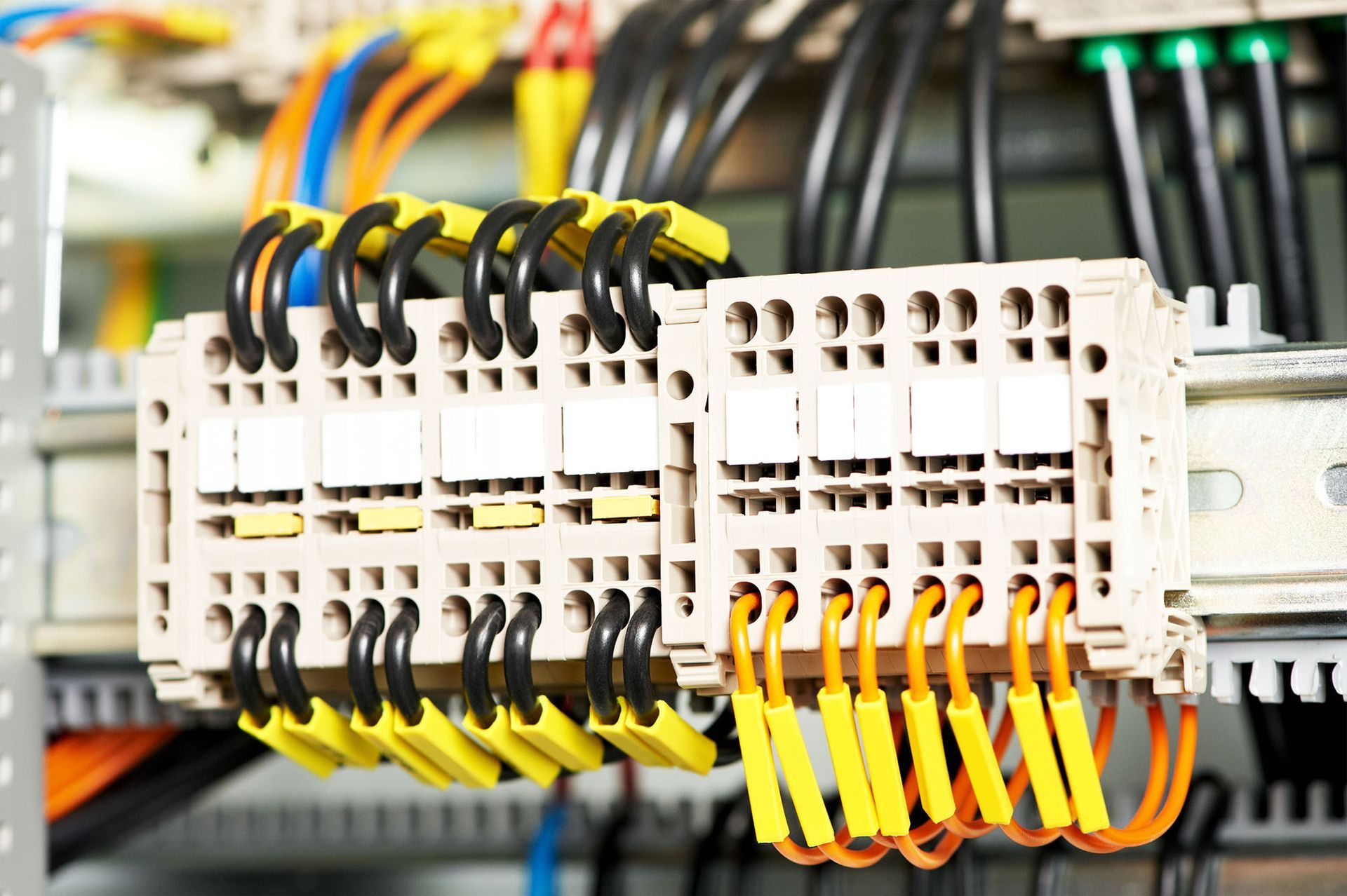 Electrical control panel with terminal blocks and colorful wires connected inside a cabinet