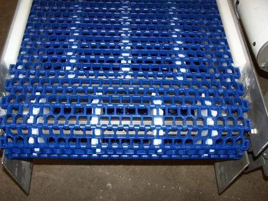 Blue metal grating platform on a vehicle or industrial cart, viewed from above.