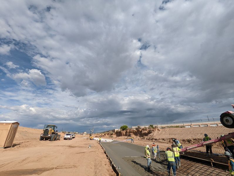 A group of construction workers are working on a road.