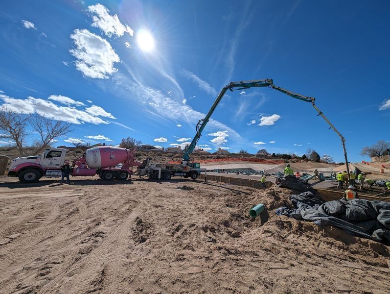 A concrete pump is being used to pour concrete on a construction site.