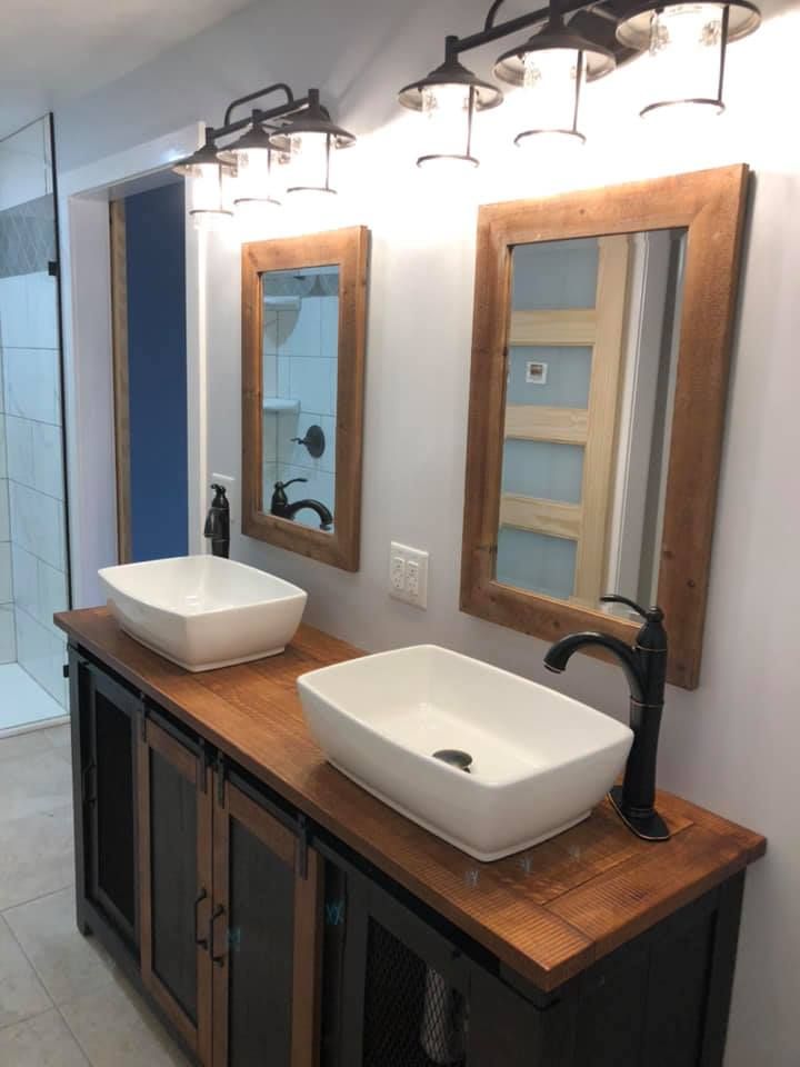 A bathroom with two sinks and two mirrors