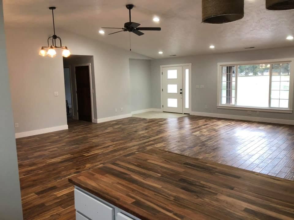 A living room with hardwood floors and a ceiling fan