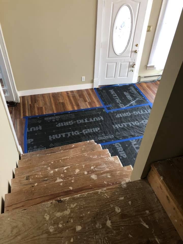 A wooden floor is being installed in a house.