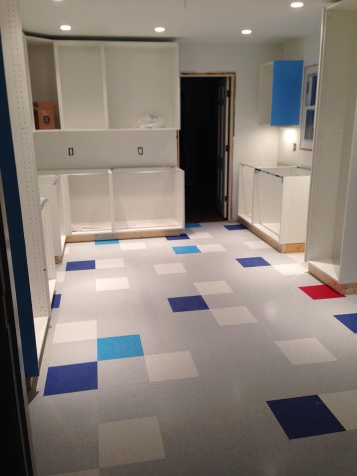A kitchen with blue white and red squares on the floor