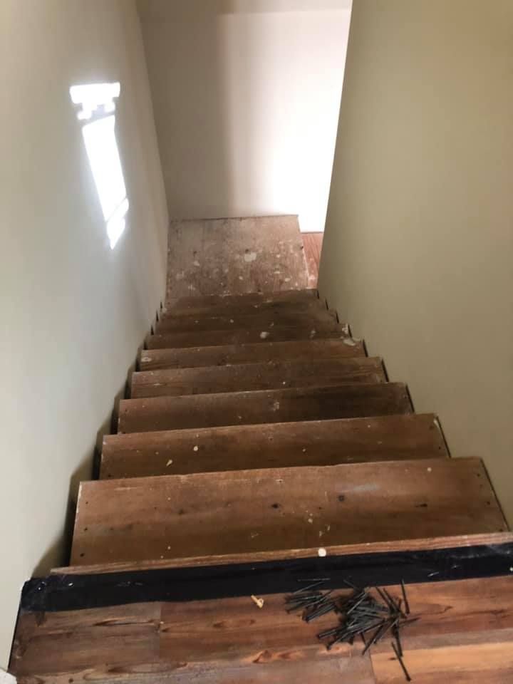 A set of wooden stairs leading up to a second floor in a house.